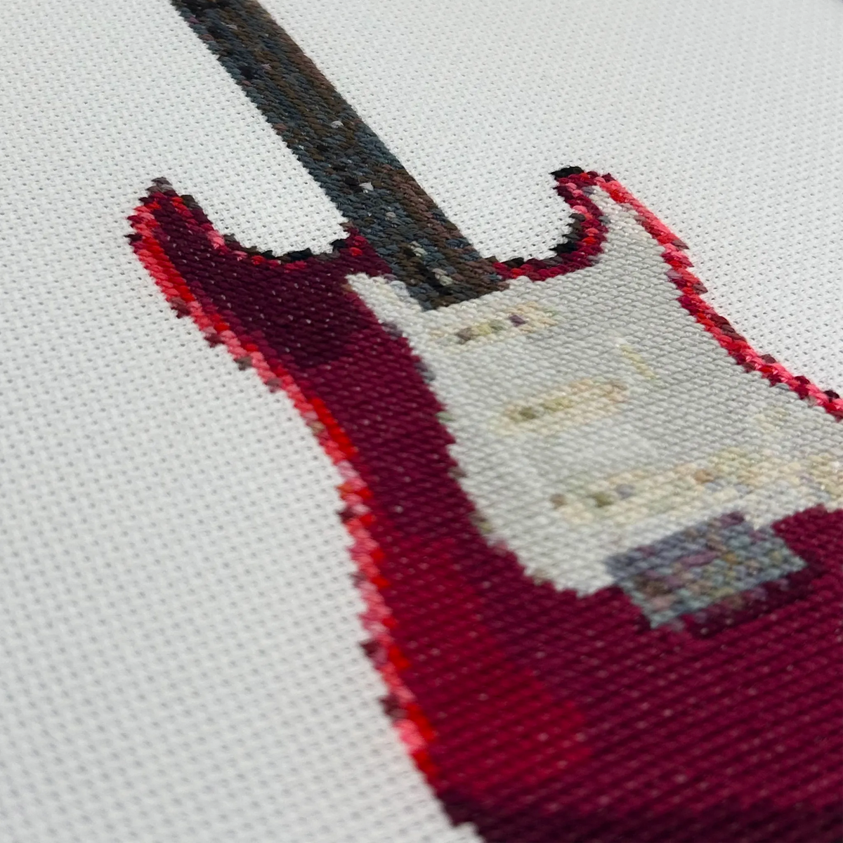Close up of fender statocaster guitar on white fabric