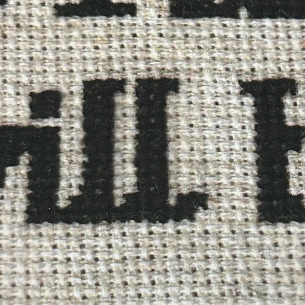 Close up of the letters of the memento mori quote embroidery.