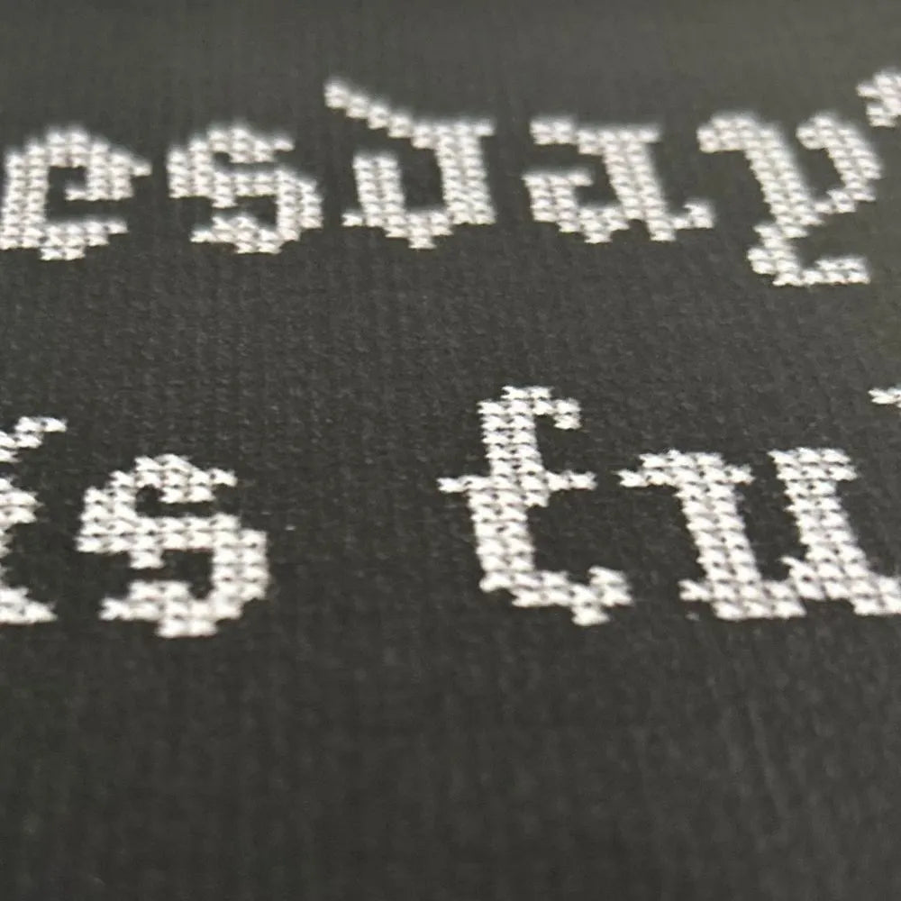 close up of wednesday's child quote embroidered style print