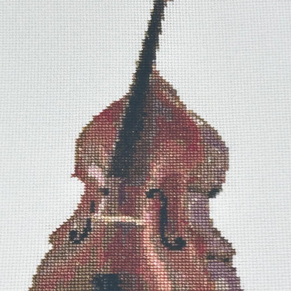 close up the A5 art print of the original embroidery design of a double bass showing realistic stitches and fabric