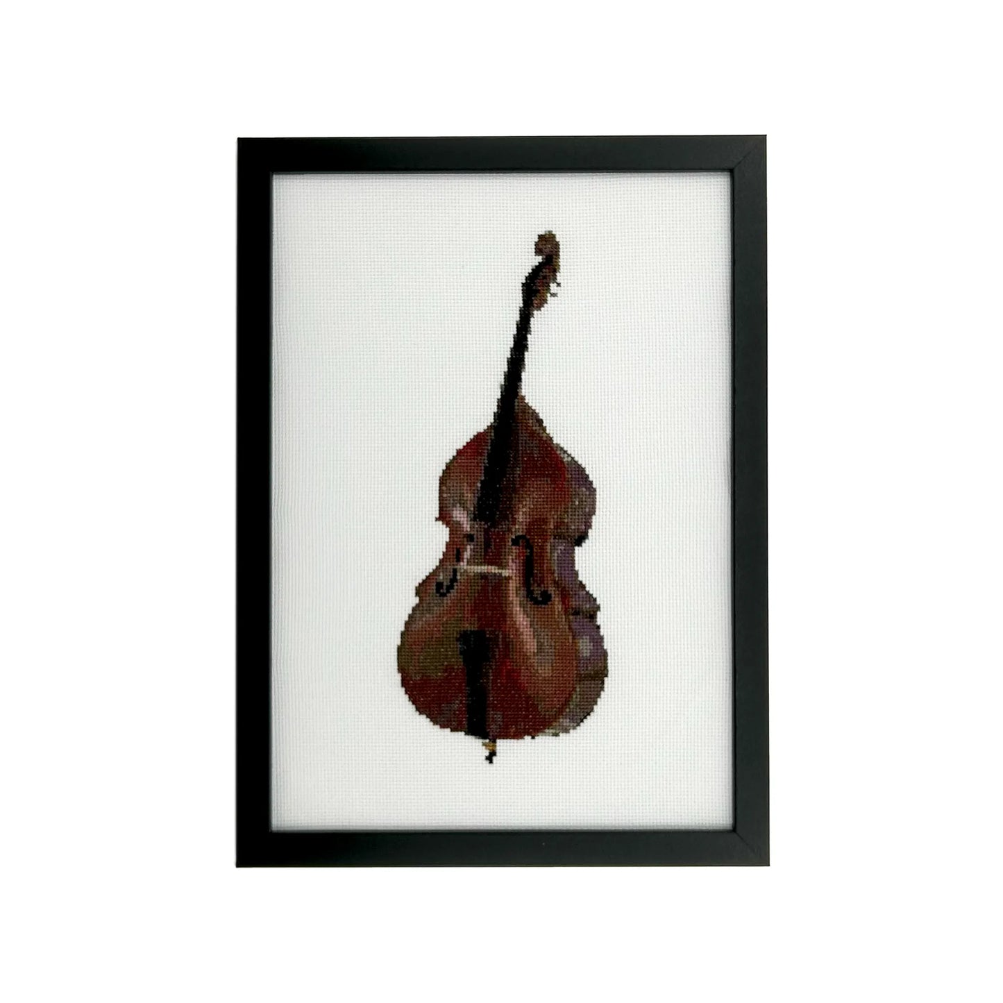 Framed cross stitch of a double bass on white fabric