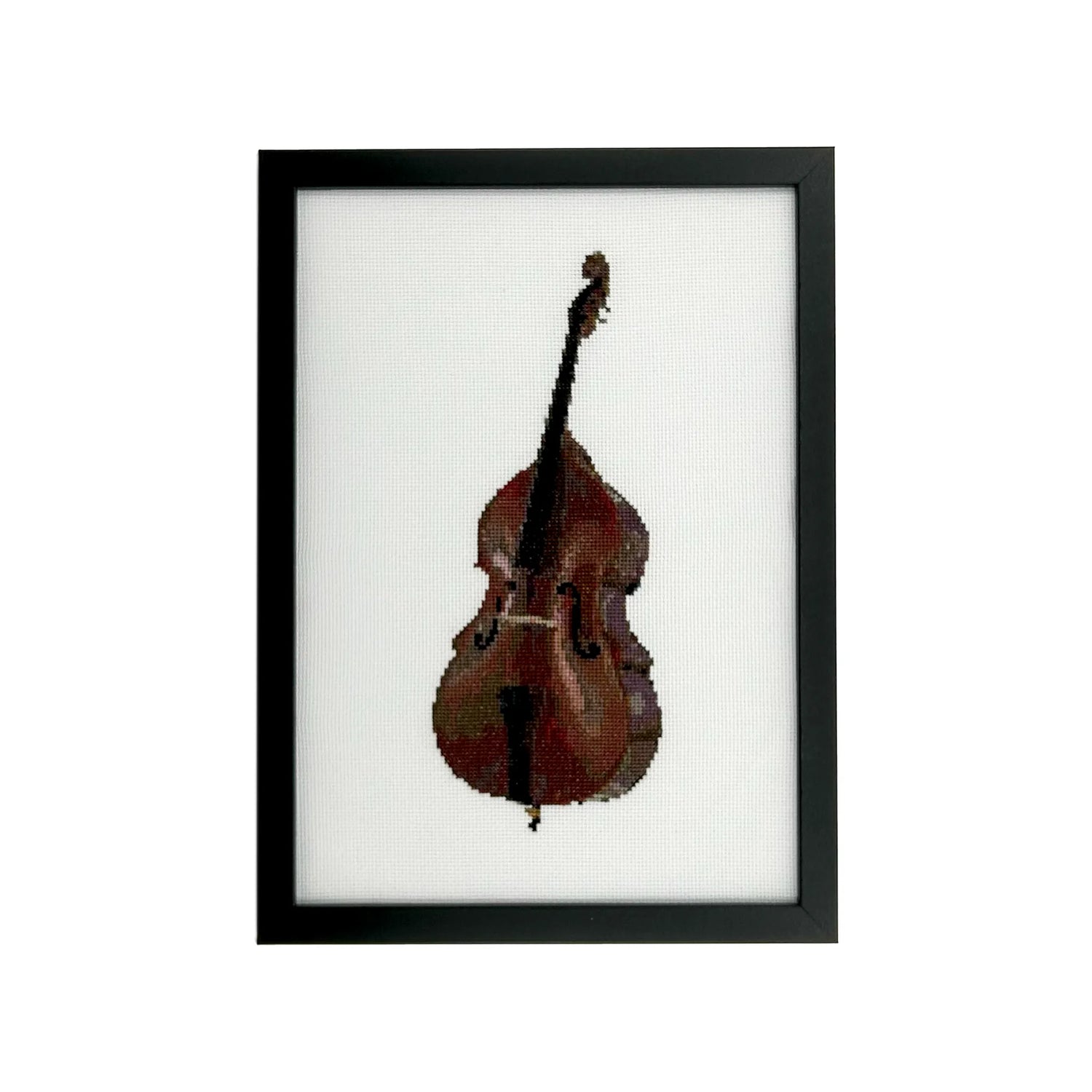 Framed cross stitch of a double bass on white fabric