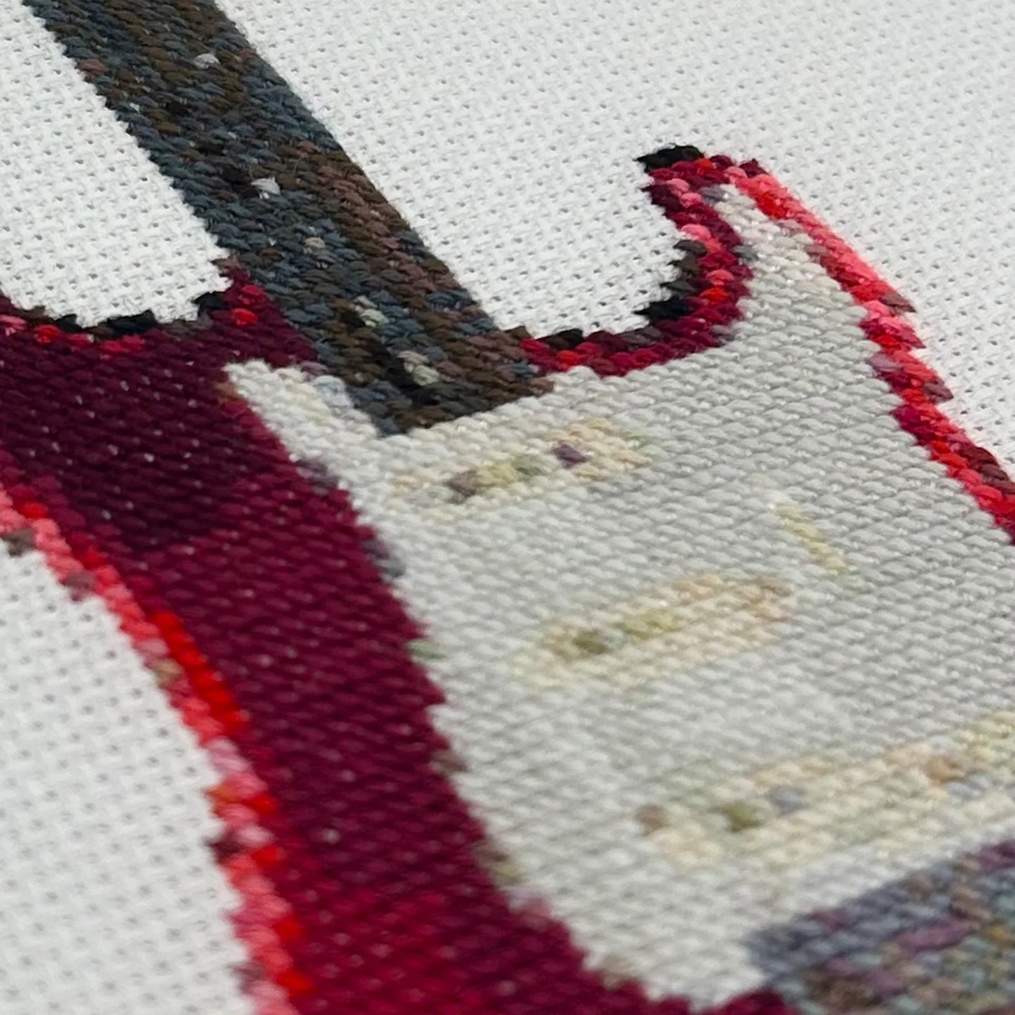 Close up of the embroidery stitches of fender stratocaster guitar on white fabric