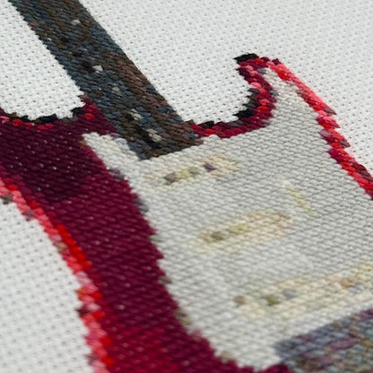 Close up of the embroidery stitches of fender stratocaster guitar on white fabric