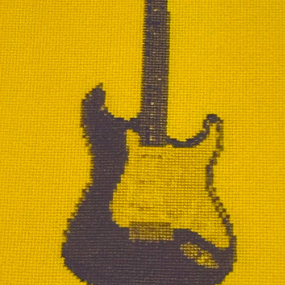 close up of colourful postcard of the original embroidery design of a fender strat