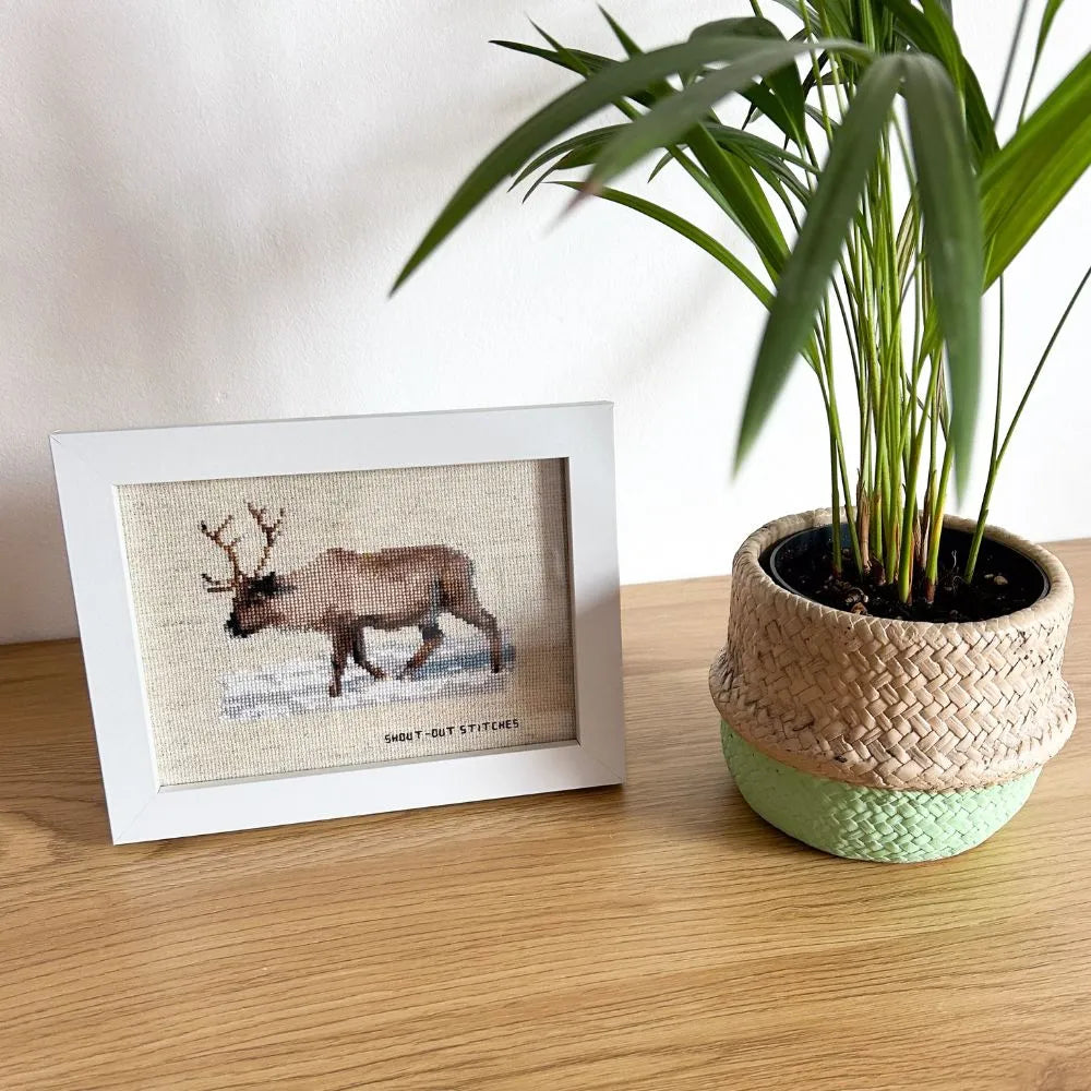 Framed reindeer in the snow embroidered artwork.