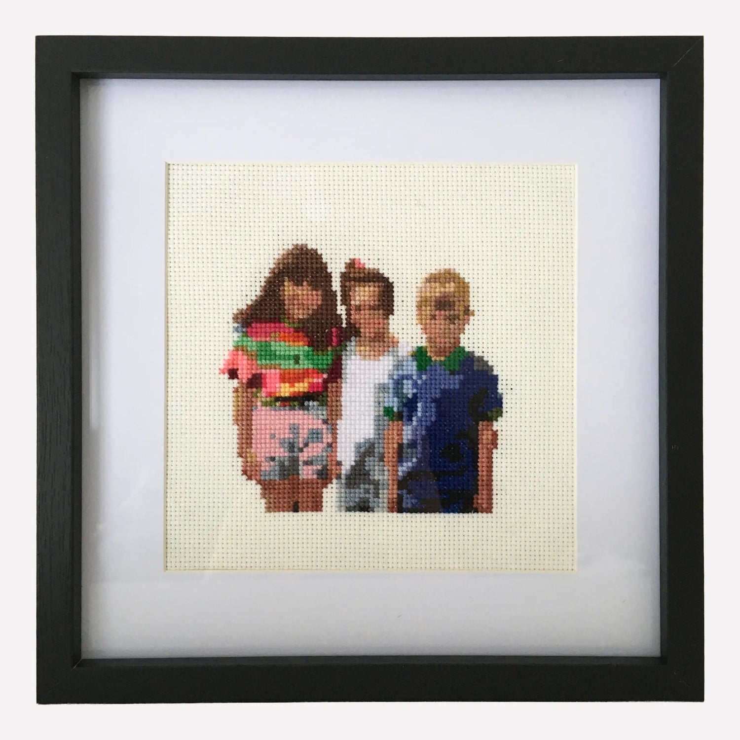 Framed custom cross stitch of three childhood friends