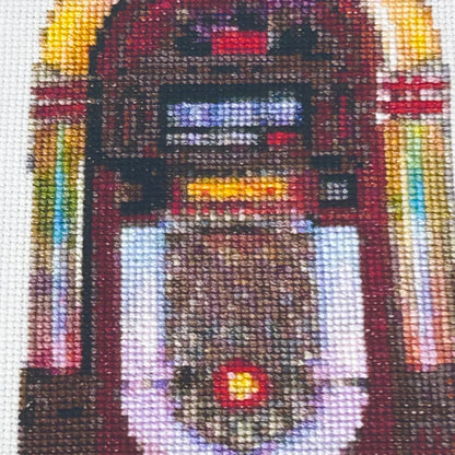 close up of the A4 art print of a retro jukebox showing realistic stitches and fabric