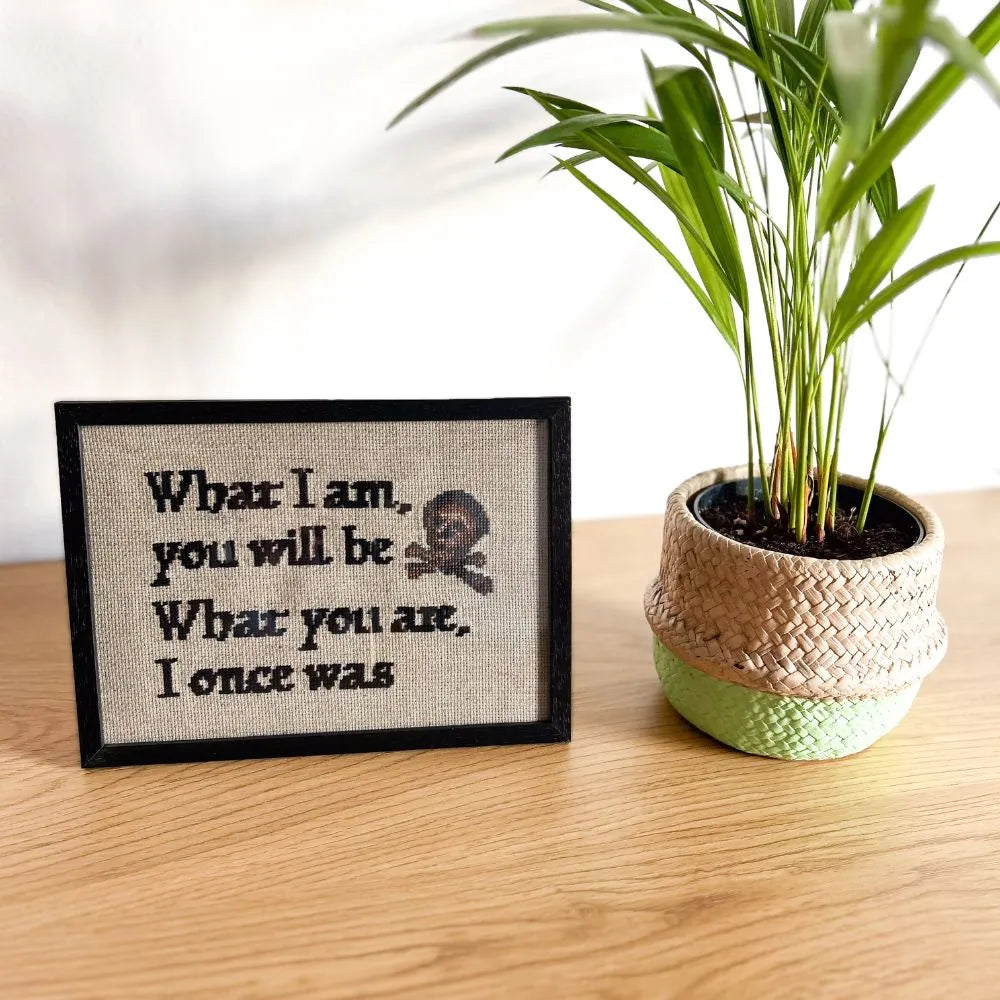 Framed memento mori quote embroidery. Reads What I am, you will be What you are, I once was. 