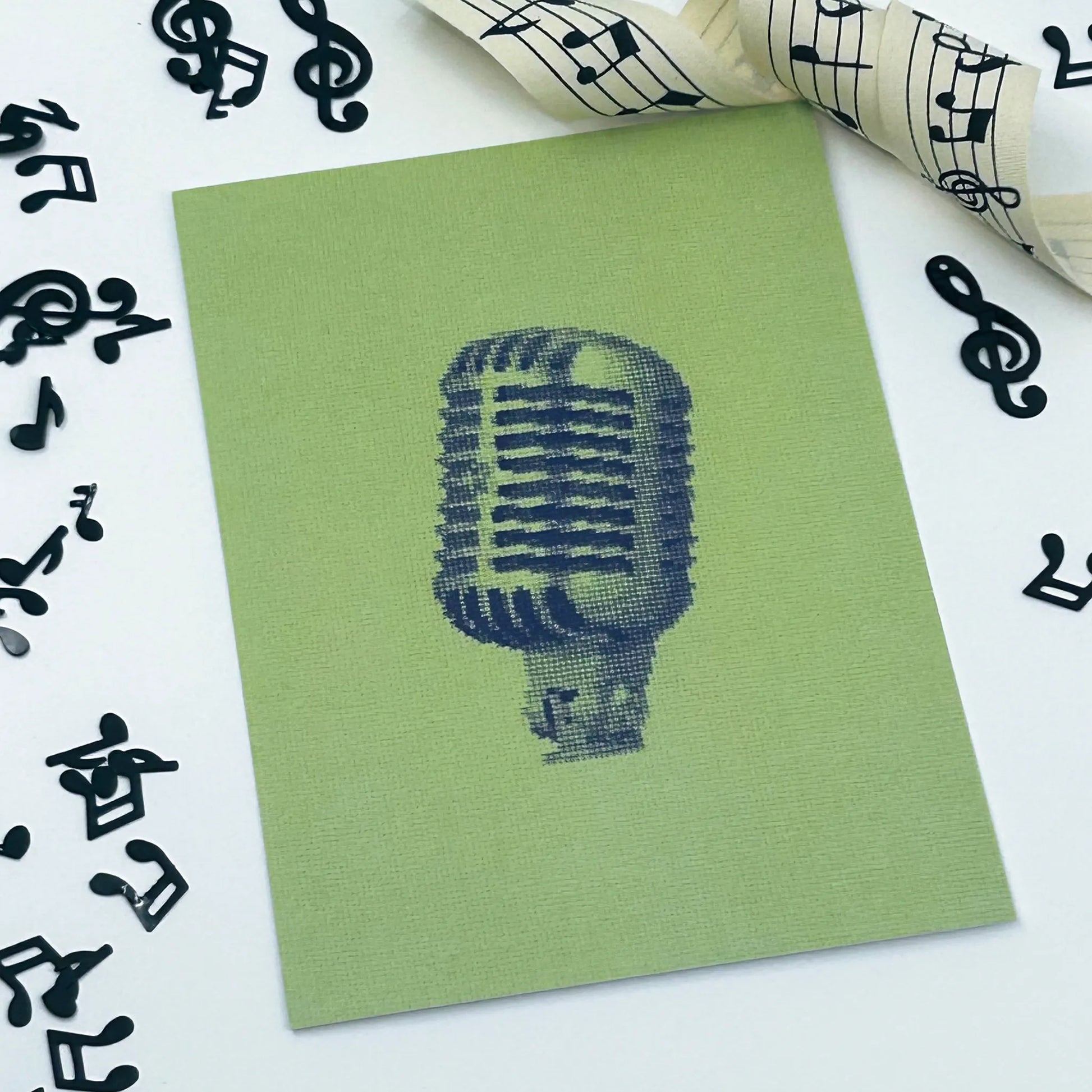 postcard of the shure 55SH mic original embroidery greyscale mic on a green background