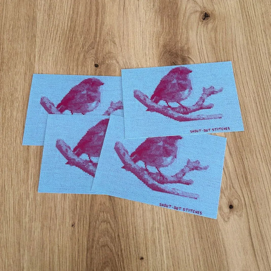 robin red breast embroidered design on a postcard with blue background and purple inverted colours